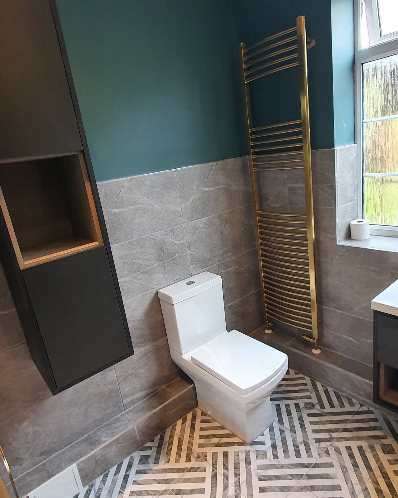 After: the finished wall with a new toilet, vanity basin and patterned floor by ATR Kitchens and Bathrooms