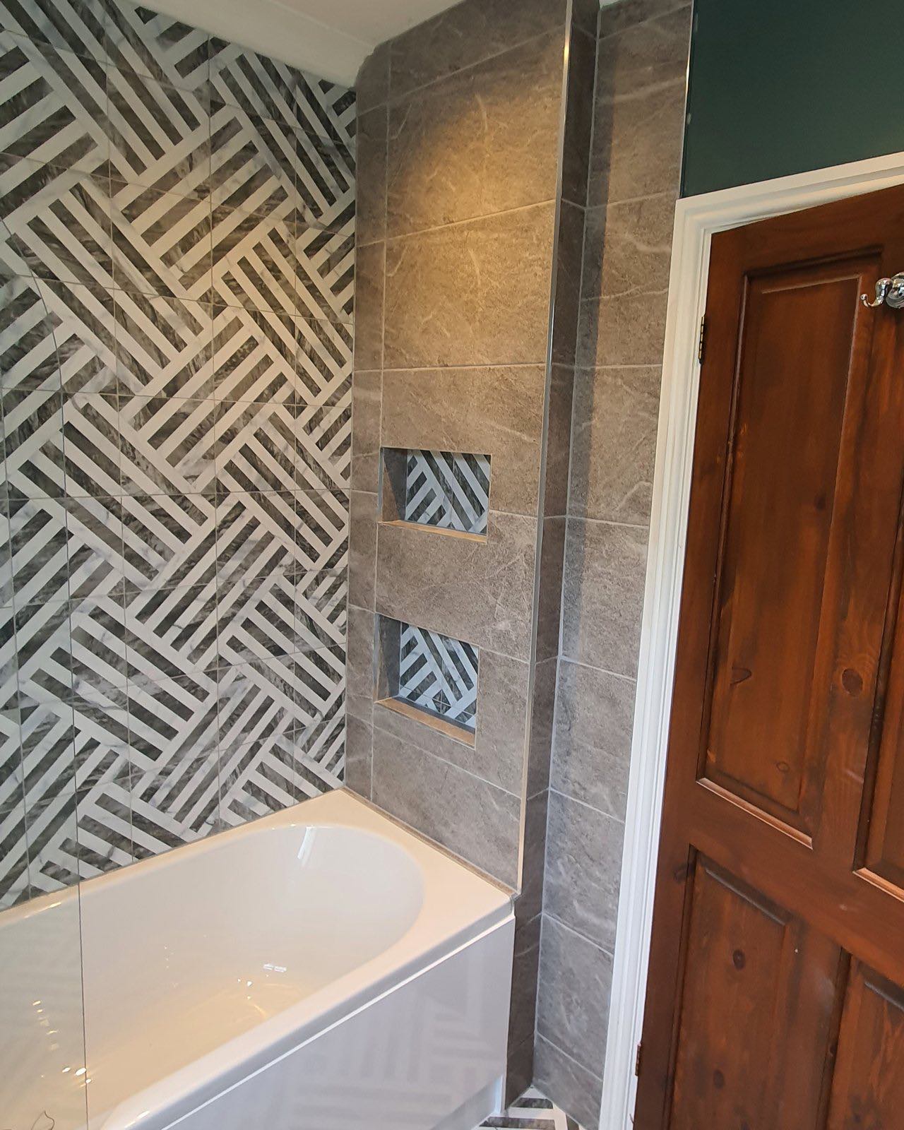 After: the finished bath with patterned feature tiles and a dark green wall by ATR Kitchens and Bathrooms