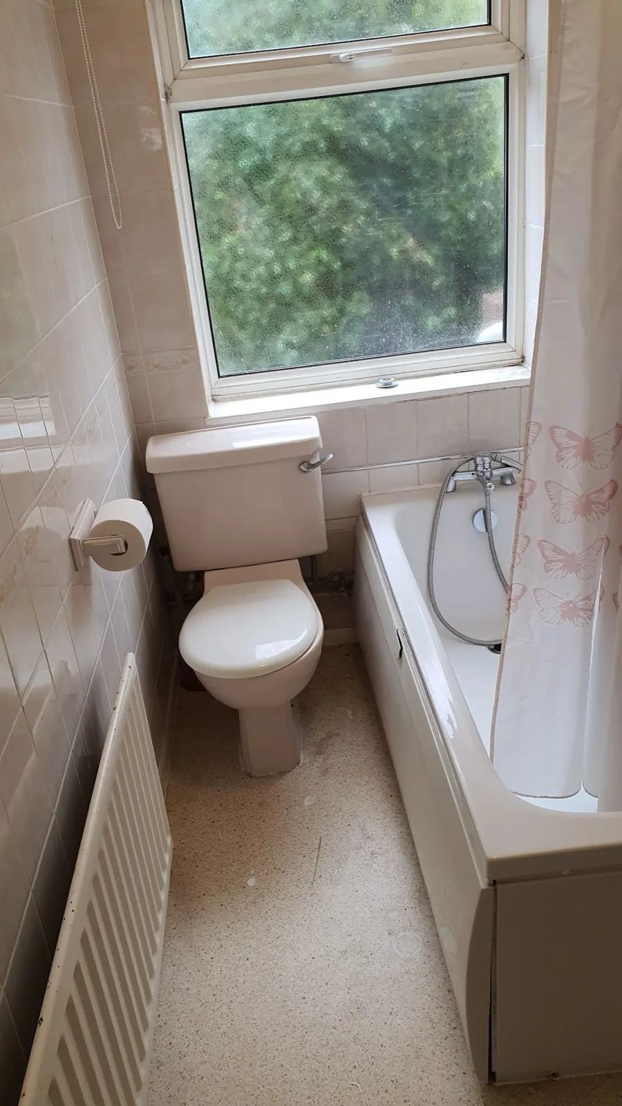 Before: the old bathroom with a dated suite and worn floor