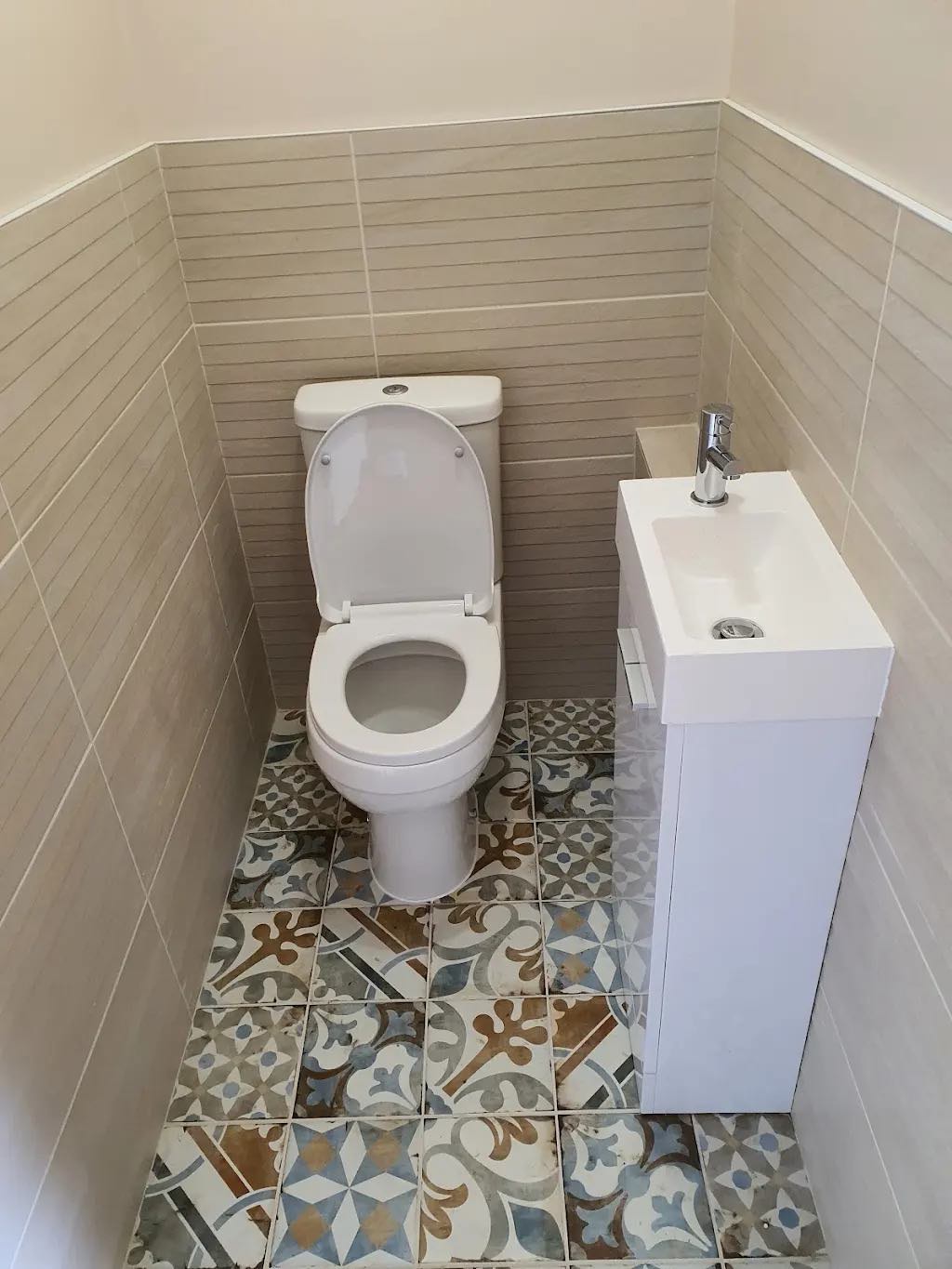 After: the refitted cloakroom with a patterned tiled floor, new toilet and slimline basin unit by ATR Kitchens and Bathrooms