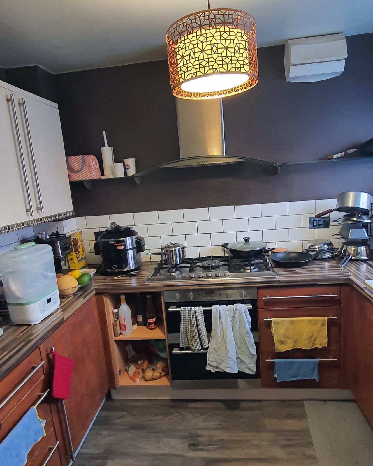 Before: the old wooden kitchen with dark walls and pans on the rail