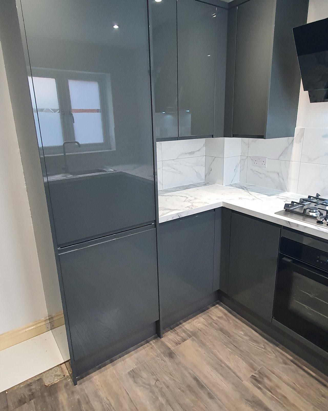 After: the finished graphite gloss kitchen with marble-effect worktop and splashback by ATR Kitchens and Bathrooms