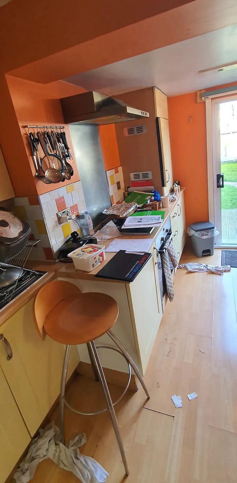 Before: the old orange kitchen with a breakfast bar before the wall came out