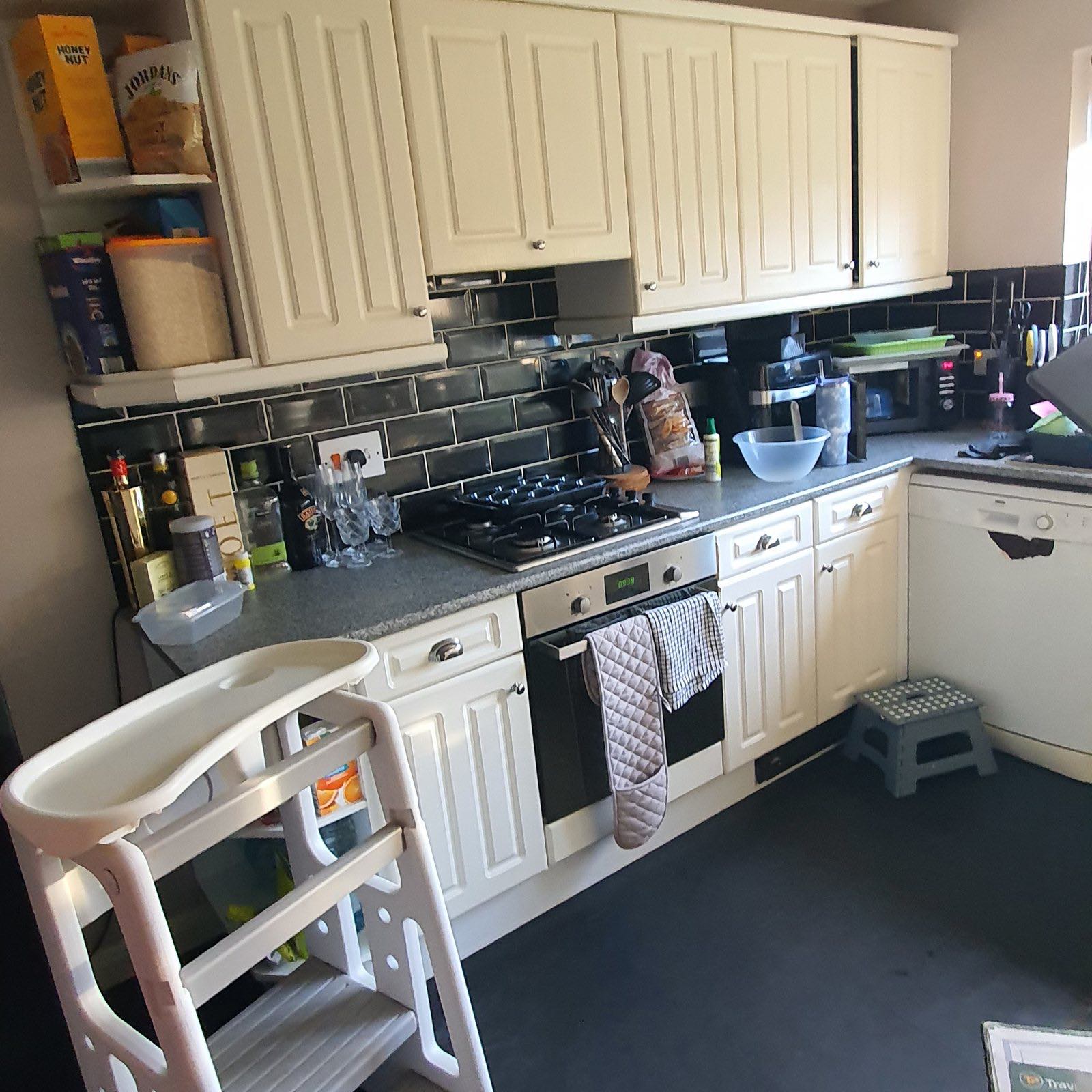 Before: the old white kitchen with black worktops before the refit