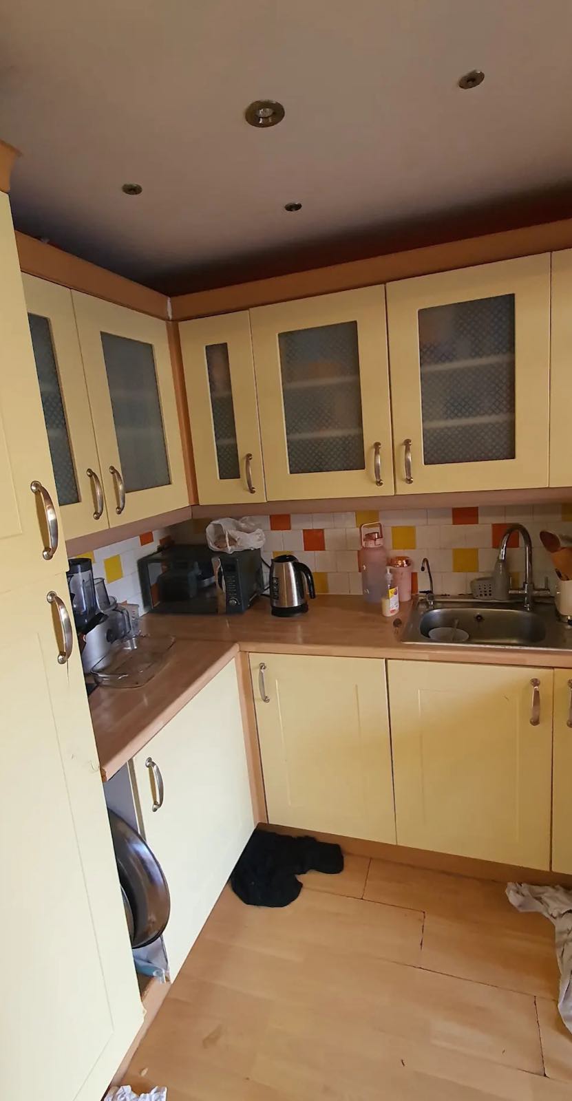 Before: the old cream shaker kitchen with glazed wall units